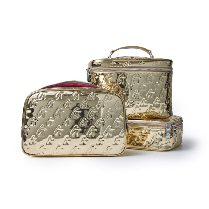 Medium metallic gold monogram toiletry bags with embossed "G" pattern, featuring zip closures and a sleek, shiny finish.