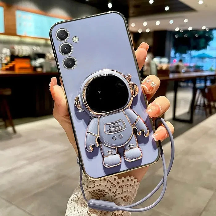 a woman holding a phone case with a camera attached to it