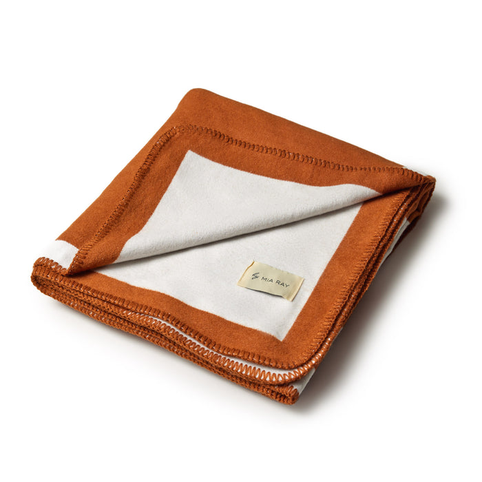 Brown classic throw blanket with a white border, folded to show soft fabric and stitched edges.