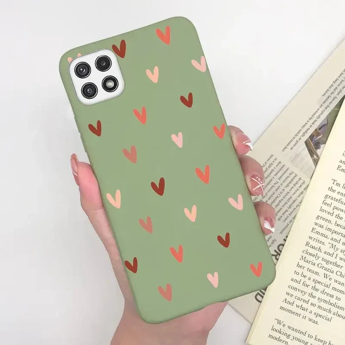 a woman holding a book and a phone case