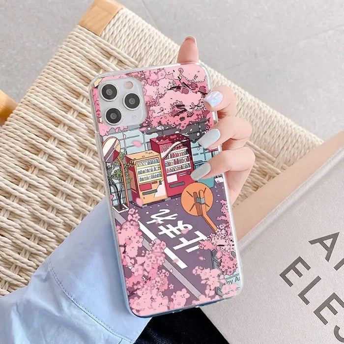 a woman holding a pink phone case with a pink flower pattern
