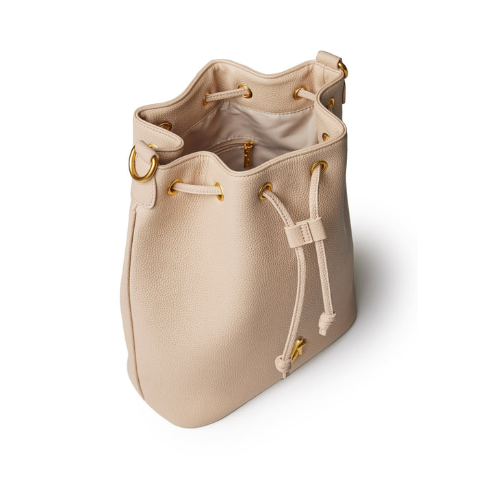 Large nude pebble bucket bag with gold hardware, drawstring closure, and interior zip pocket.