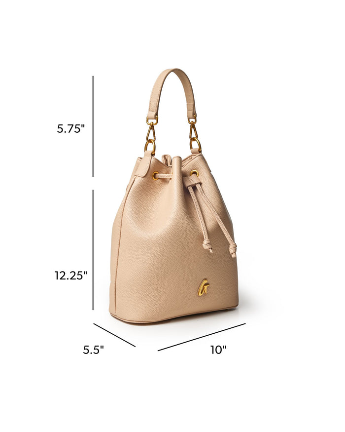 LARGE PEBBLE BUCKET BAG in nude with gold accents, featuring a drawstring closure and stylish silhouette.