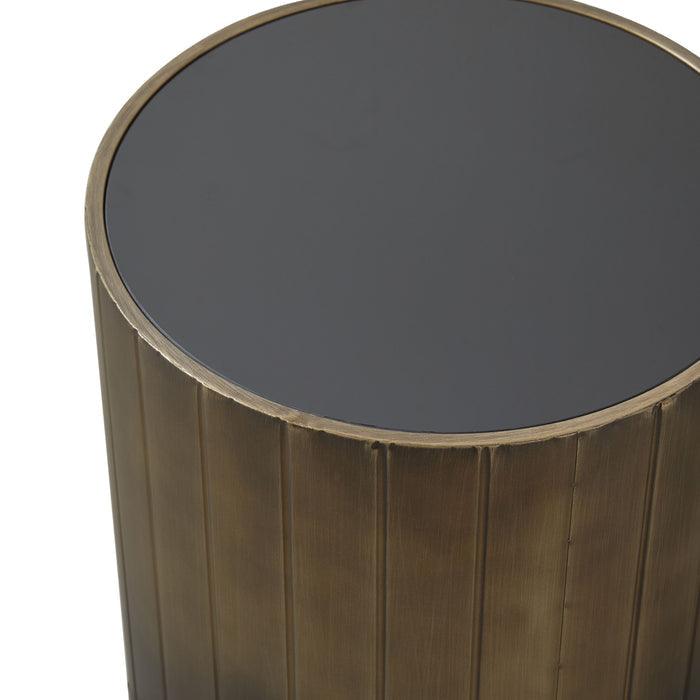 The Lola Drum Side Table 42x42x45cm features a dark, glossy top and vertically grooved, powder-coated metallic bronze base, making it an elegant accent piece shown from an angled top perspective.