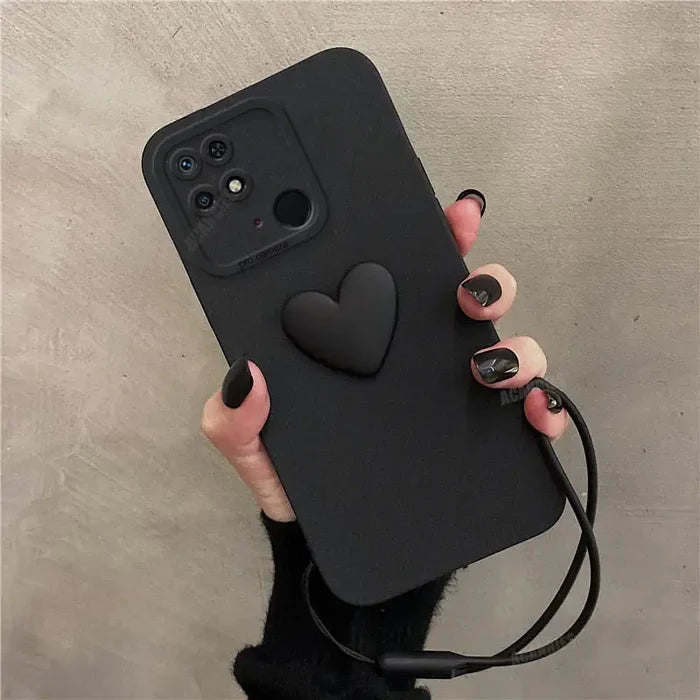 a woman holding a black phone case with a heart on it