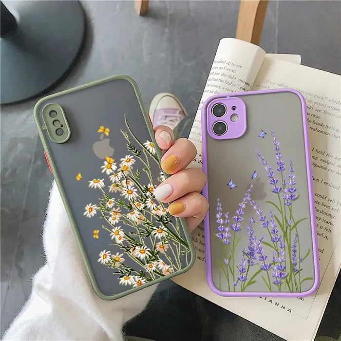 a woman holding a phone case with flowers on it