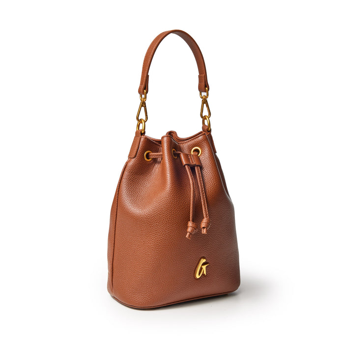 Medium brown pebble-textured bucket bag with gold hardware, drawstring closure, and a top handle.