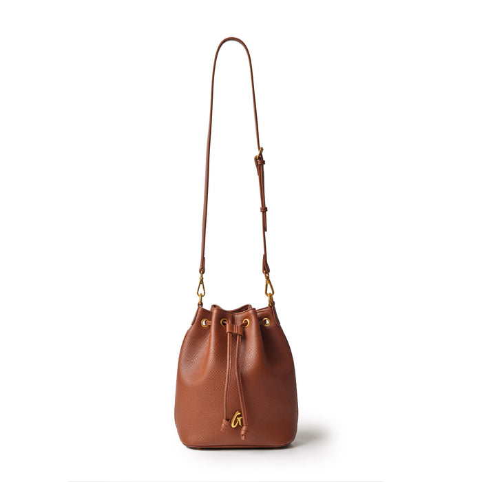 Medium brown pebble-textured bucket bag with a drawstring closure and adjustable shoulder strap.