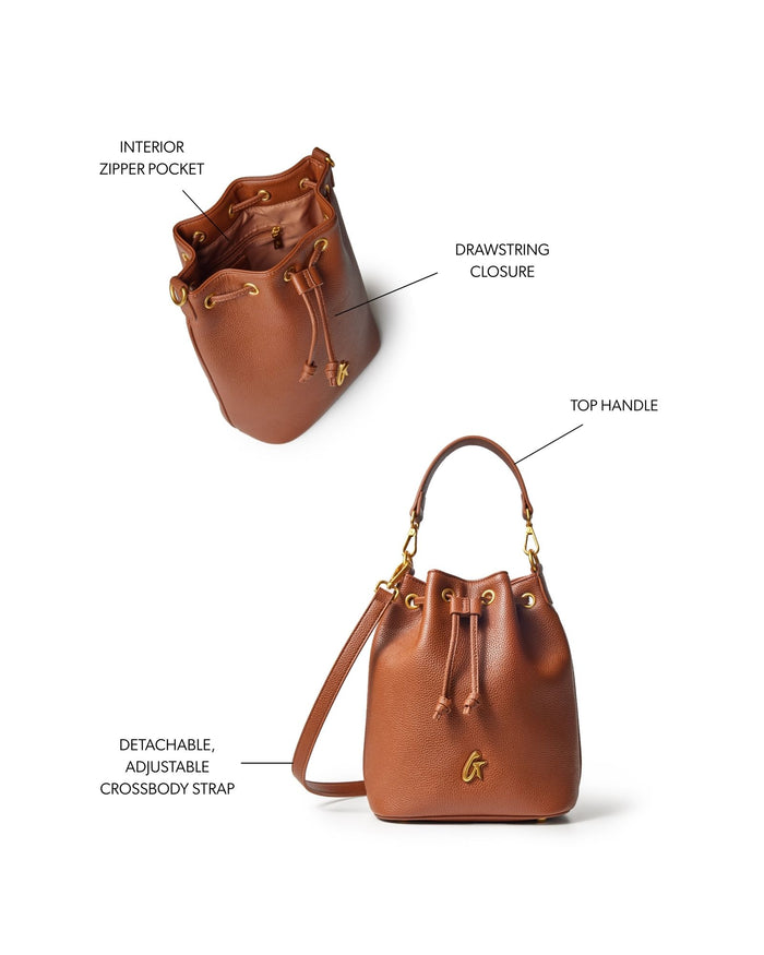 Medium brown pebble bucket bag featuring a drawstring closure, top handle, and detachable adjustable crossbody strap.