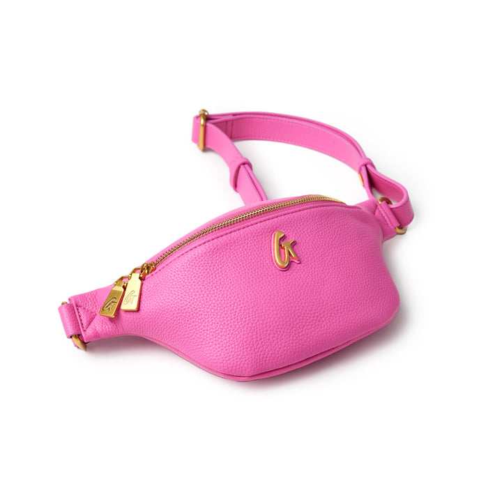 Mini pink pebble leather fanny pack with gold zipper, logo detail, adjustable strap, and compact design.