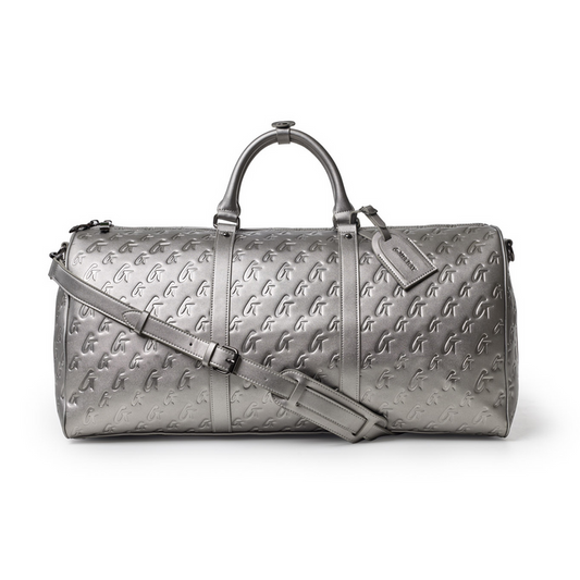 Platinum monogram duffle bag featuring embossed logo, dual handles, and a detachable shoulder strap. Perfect for stylish travel.