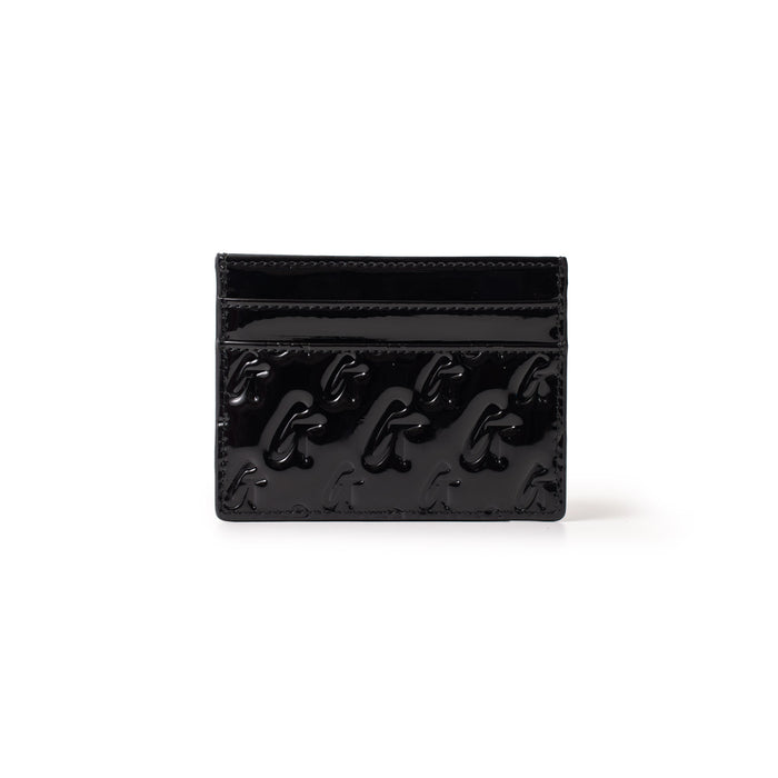 Monogram gold card holder in mirror black with embossed logo pattern and multiple card slots.