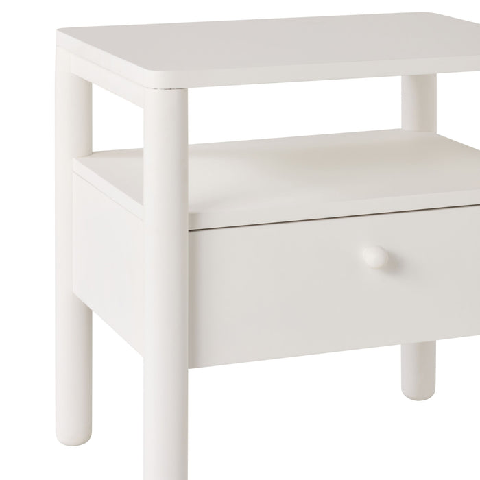 The Spintara 1 Drawer Bedside Table White features a single drawer with a round knob, rounded legs, and an open shelf—ideal for bringing coastal country style charm to your bedroom.